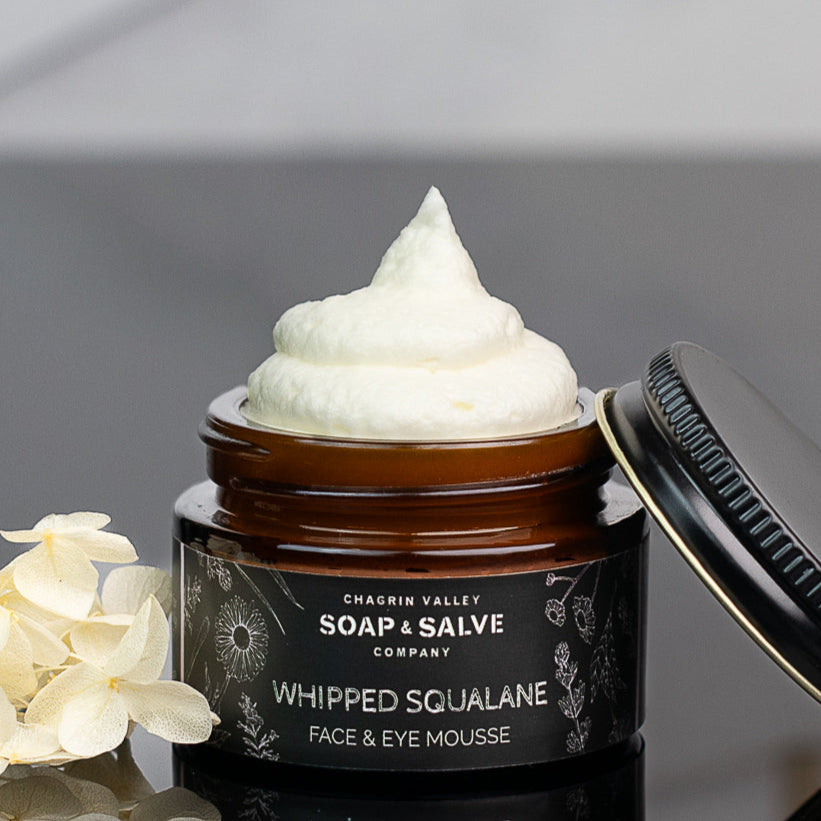 organic squalane face and eye cream near flowers and lid