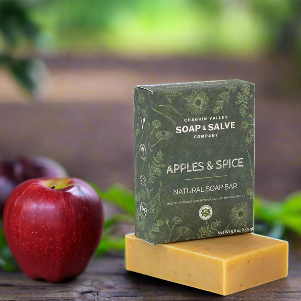 Soap bar with 'Chagrin Valley Soap & Salve Company' packaging next to an apple on a wooden surface.