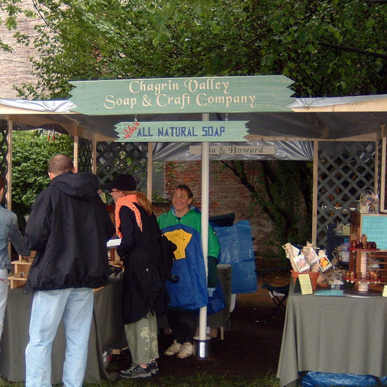 Outdoor event with Chagrin Valley Soap & Craft Company booth selling all natural soap.