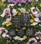 Cosmetic products from Soap & Salve Company on a bed of flowers