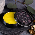 Open tin of Calendula Salve, a multipurpose botanical salve for dry, delicate skin