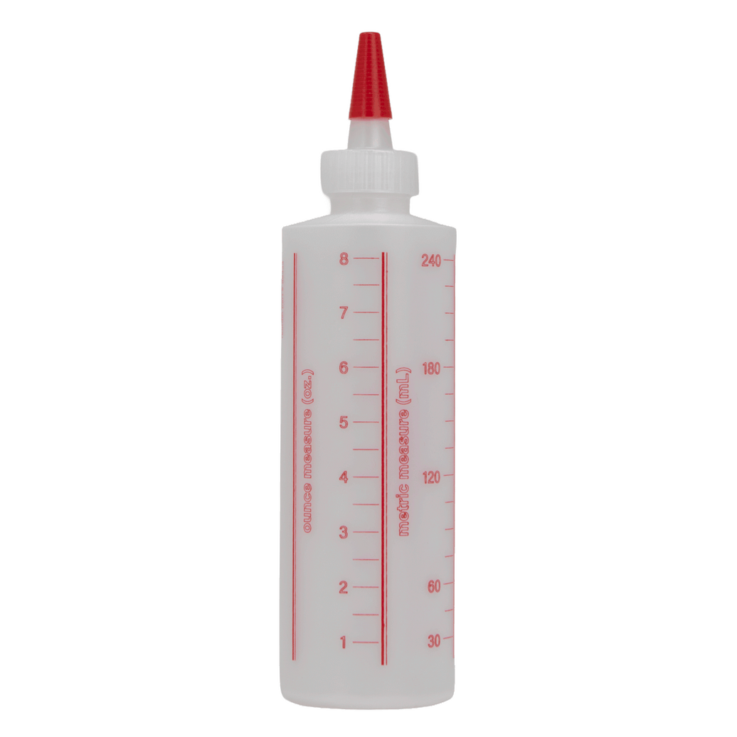 A translucent white squeeze bottle with a red pointed nozzle and red printed measurement markings on the side, shown against a plain white background.